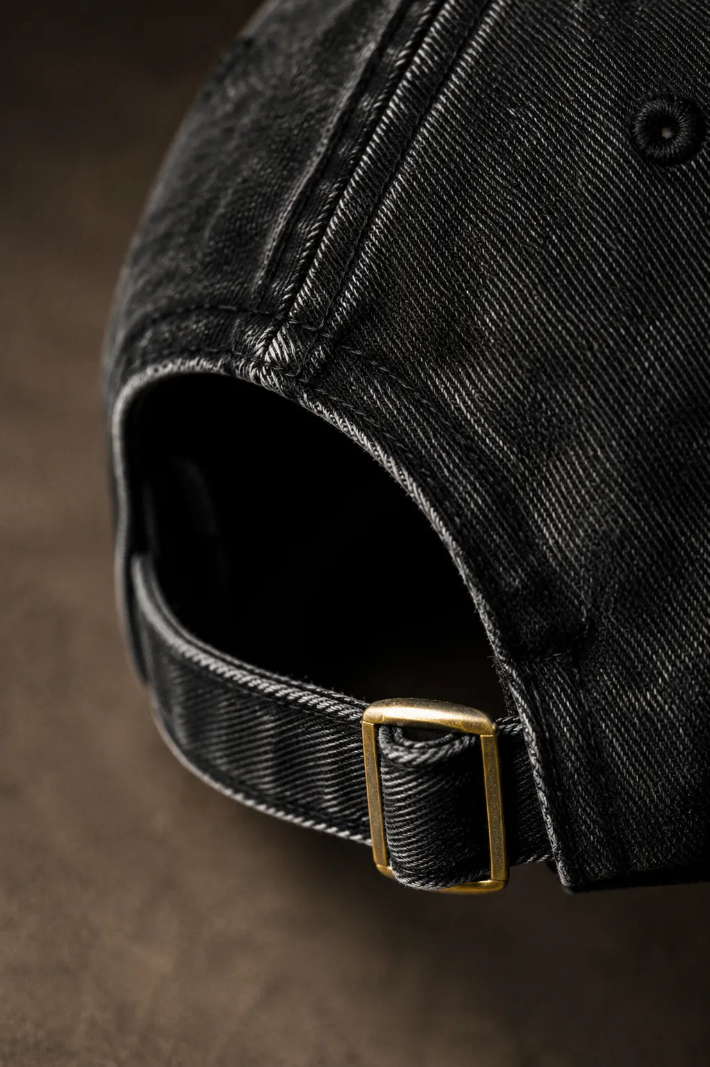 Close-up detail of the antique brass buckle and premium cotton twill fabric on the BRTLS Black Presence Vintage Cap