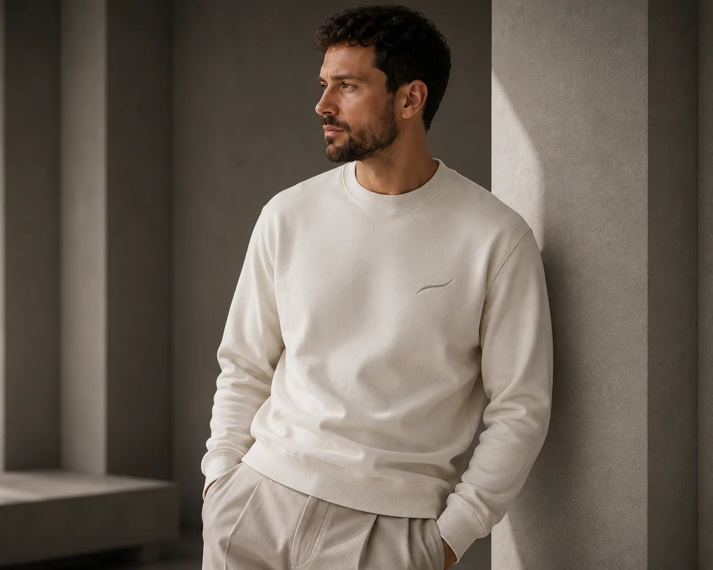 Man wearing the BRTLS Core Crewneck Sweatshirt in off-white, showcasing refined layering, premium fit and everyday presence.
