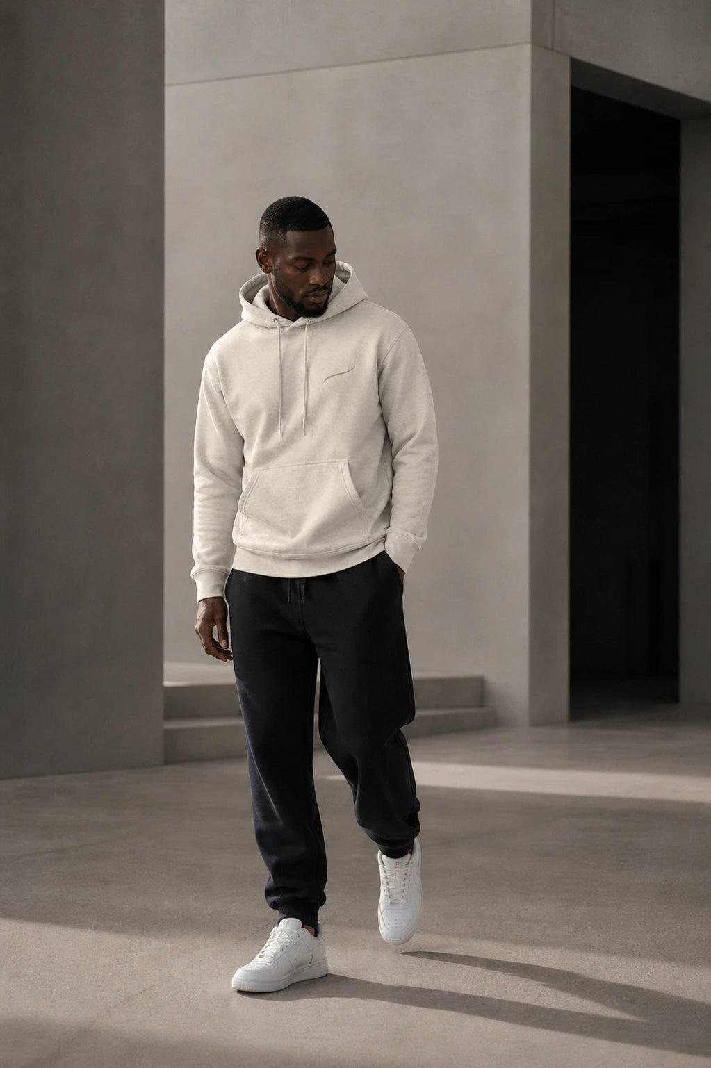 Man walking in the BRTLS Core Hoodie Bone styled for modern everyday wear