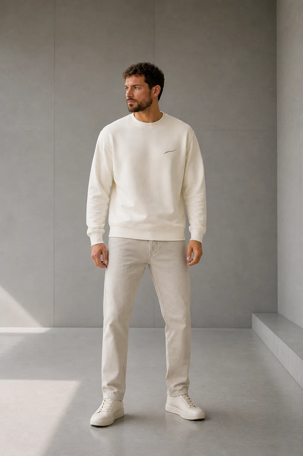 Man wearing the BRTLS Core Sweatshirt Bone showcasing the comfortable regular fit and structured silhouette designed for everyday wear.