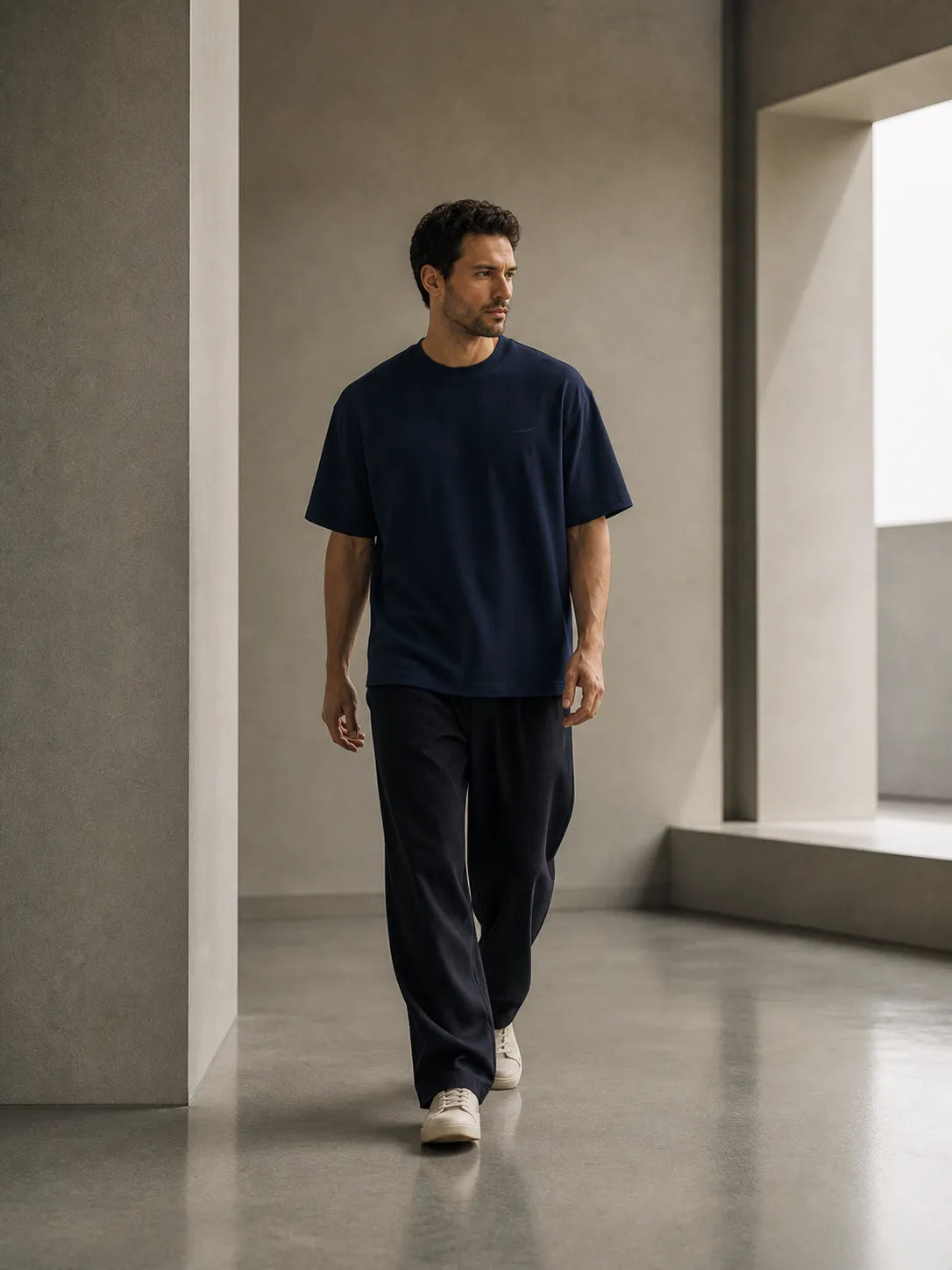 Man walking in the BRTLS Core Tee Navy Blazer demonstrating comfort, movement and timeless everyday style.