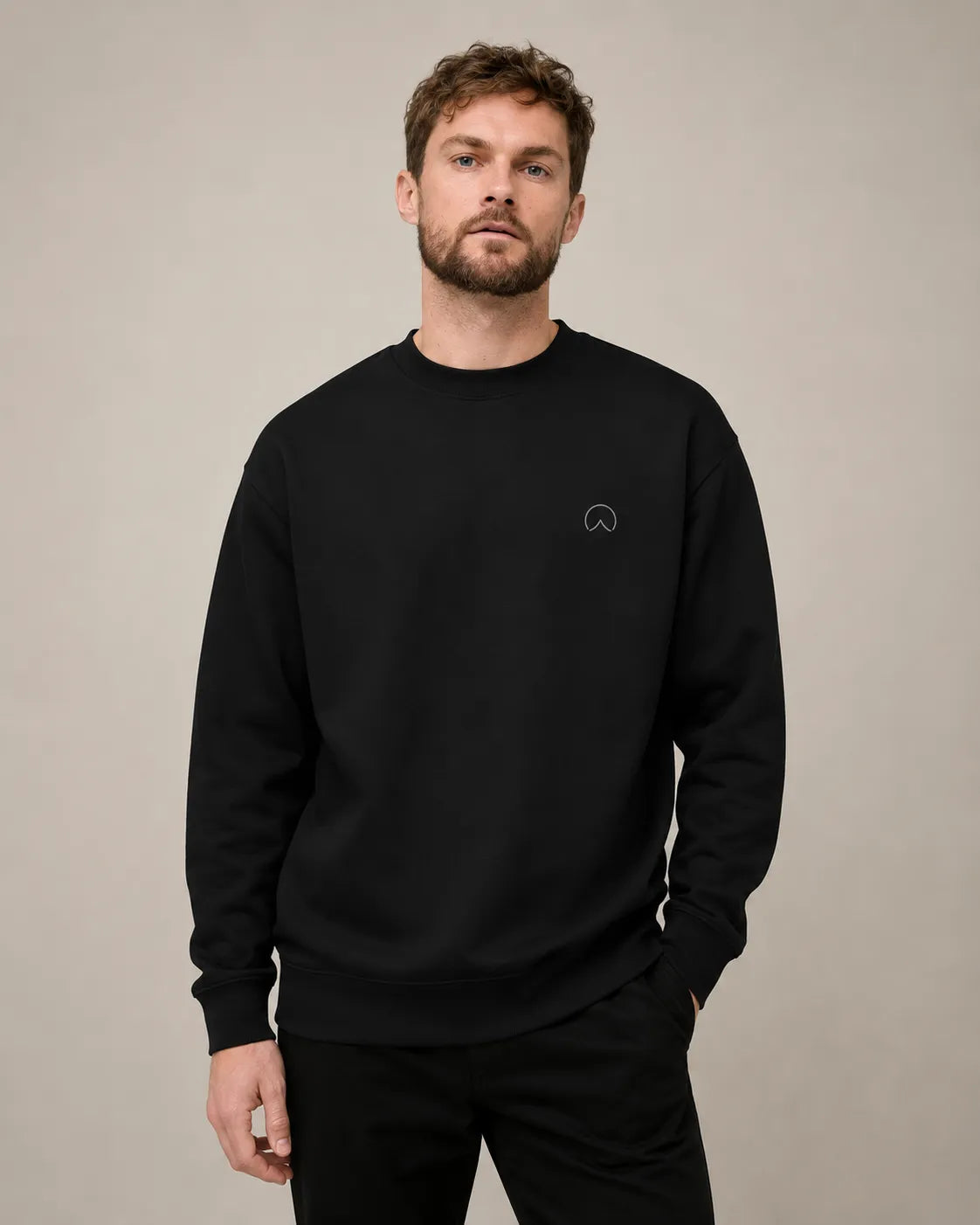 Male model wearing the black BRTLS Own Your Presence sweatshirt with relaxed premium Scandinavian styling