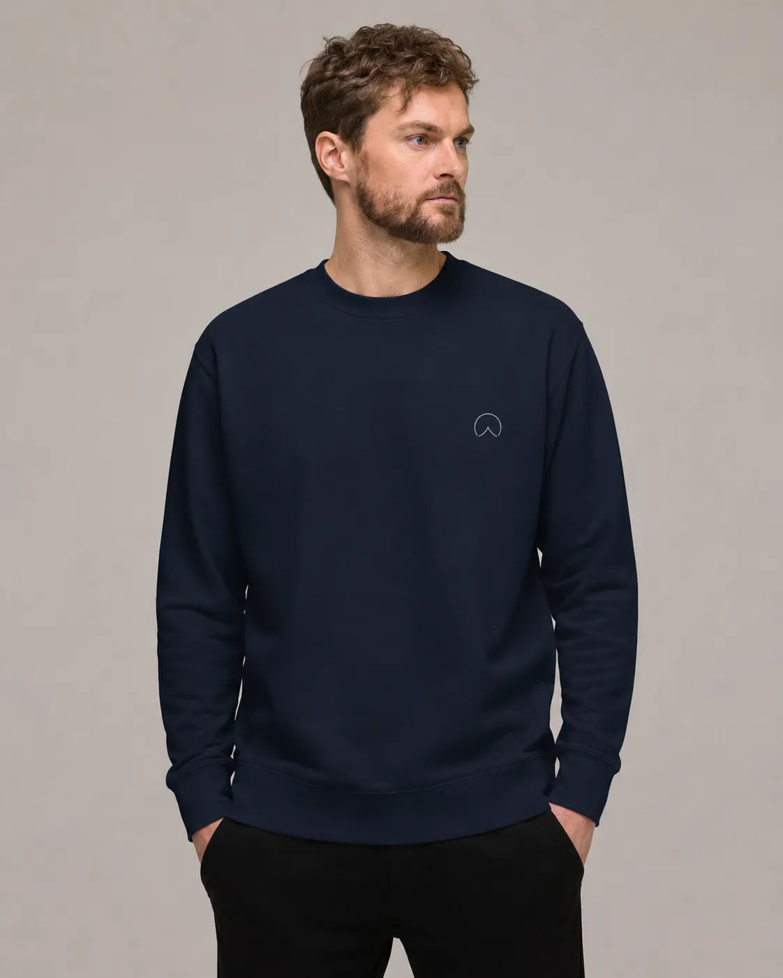 Man wearing BRTLS Own Your Presence Navy Sweatshirt with minimal front embroidery and relaxed premium fit