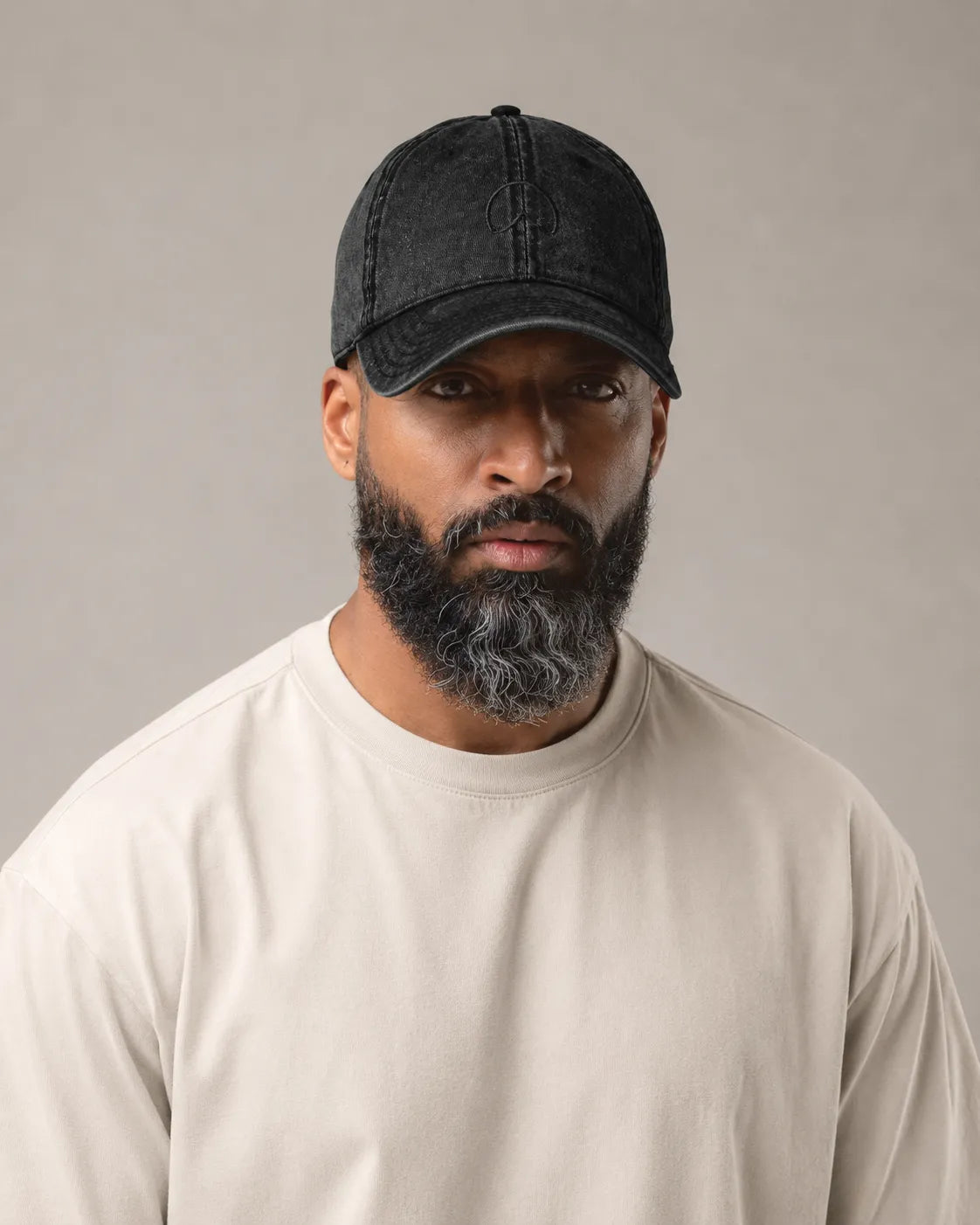 Man wearing the BRTLS Black Presence Vintage Cap with washed black cotton twill and tonal embroidered mark
