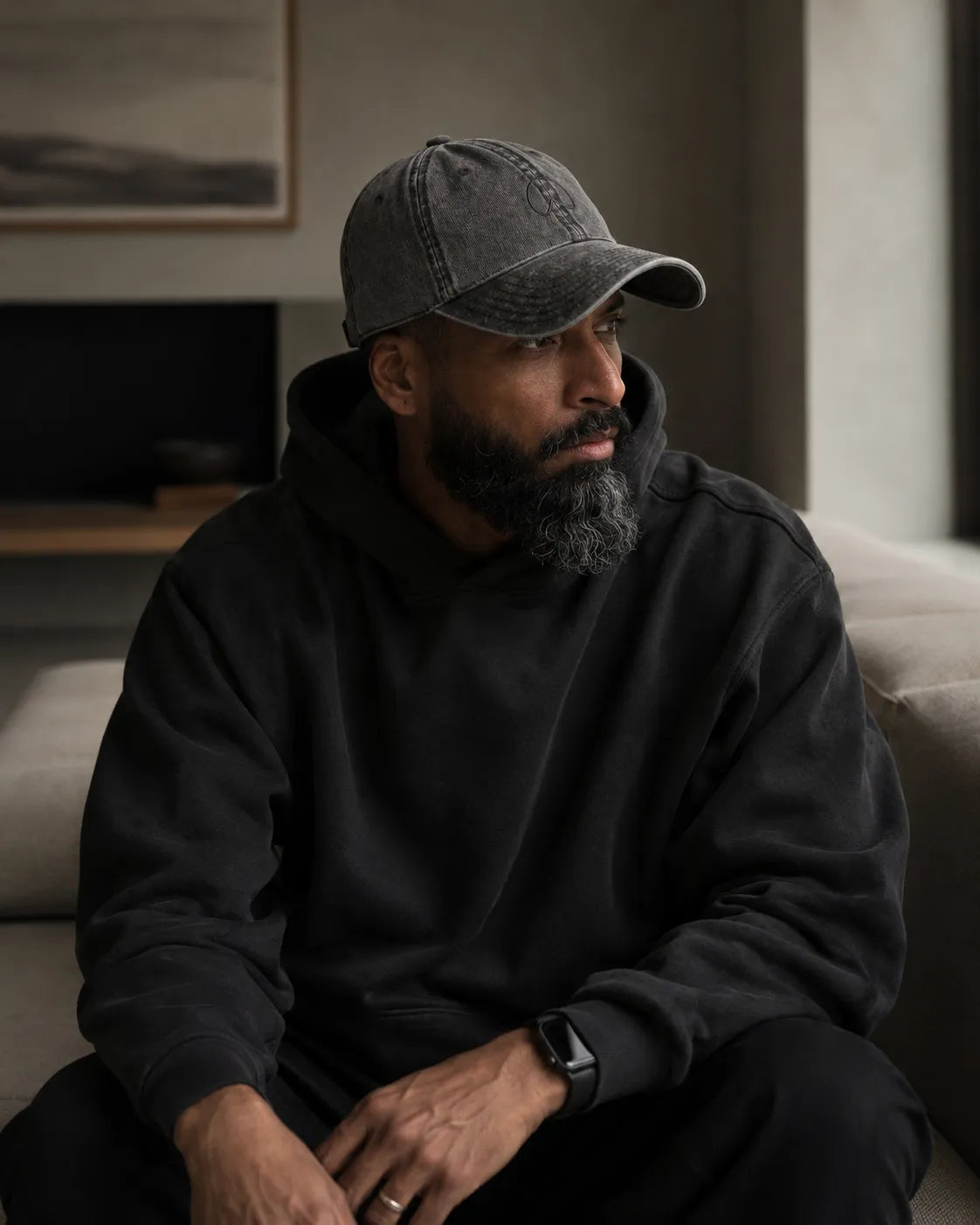 Modern father wearing the BRTLS Charcoal Grey Presence Vintage Cap in a minimalist interior