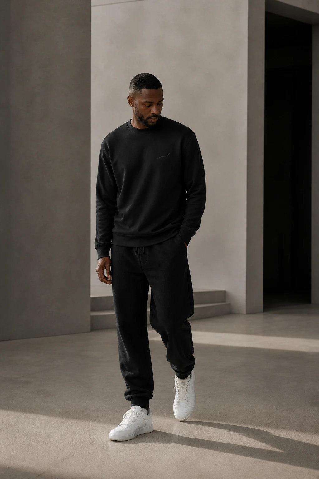 Man wearing the BRTLS Core Sweatshirt Black showcasing the relaxed fit and structured everyday silhouette