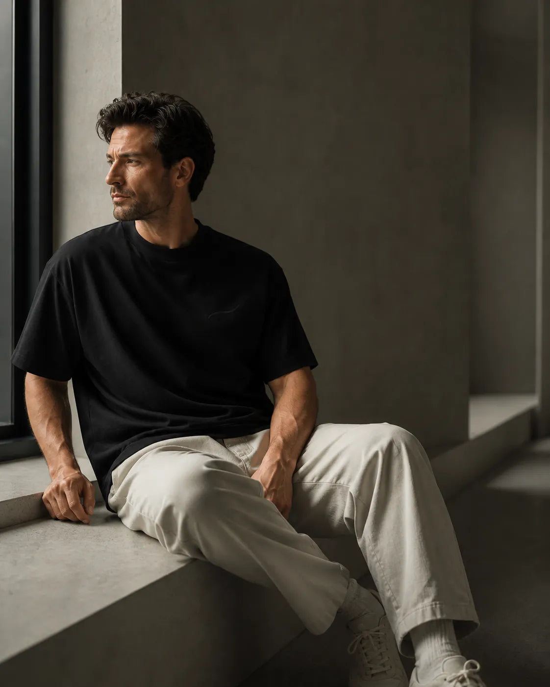 Editorial lifestyle portrait featuring the BRTLS Core Tee Black expressing calm confidence, presence and intentional living.