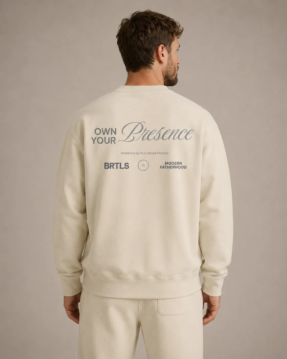 Back view of the BRTLS Own Your Presence sweatshirt in bone featuring tonal artwork