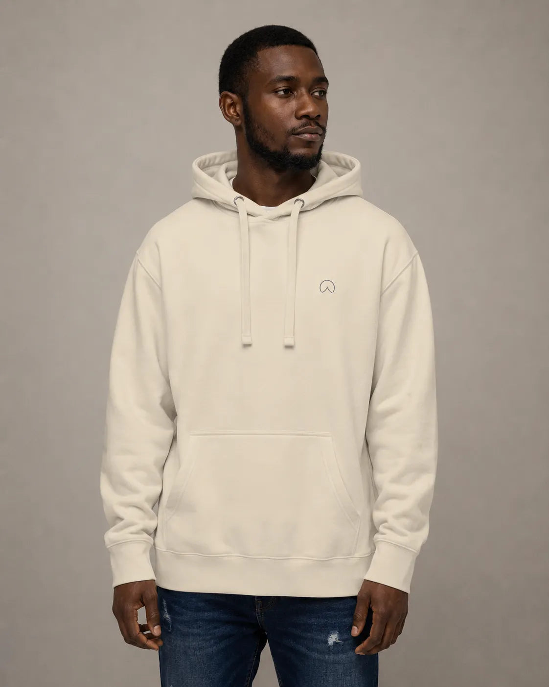 Front view of the BRTLS Presence Hoodie in bone with relaxed heavyweight fit and minimalist embroidery