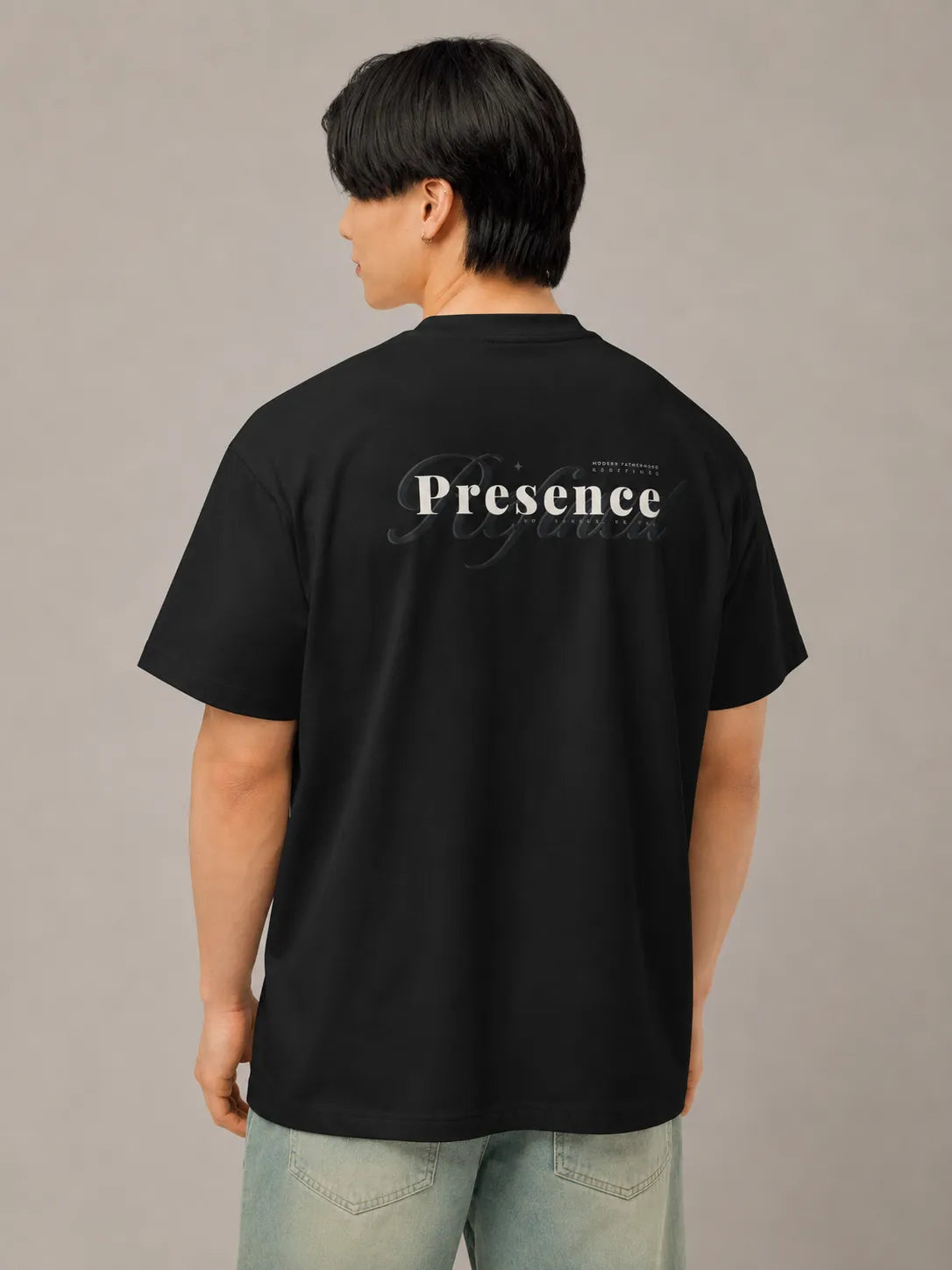 Back view of the BRTLS Refined Presence Tee Black featuring tonal Presence artwork and oversized silhouette
