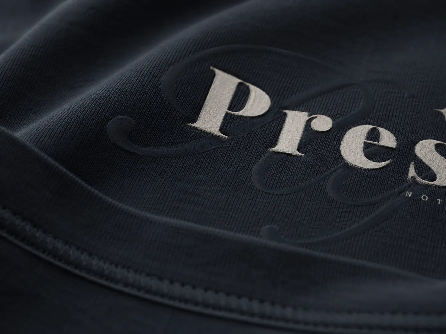 Close-up detail of the BRTLS Refined Presence Tee Navy Blazer showing heavyweight cotton texture and tonal Presence artwork